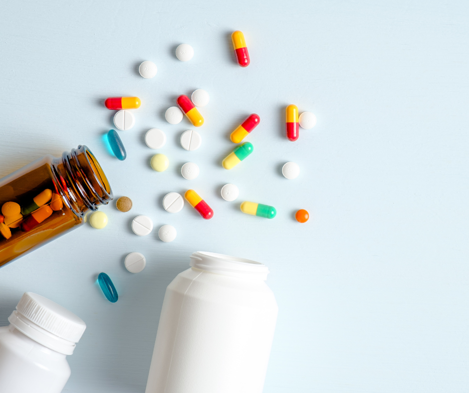 Pills scattered on a table to represent medications that impact kidney health